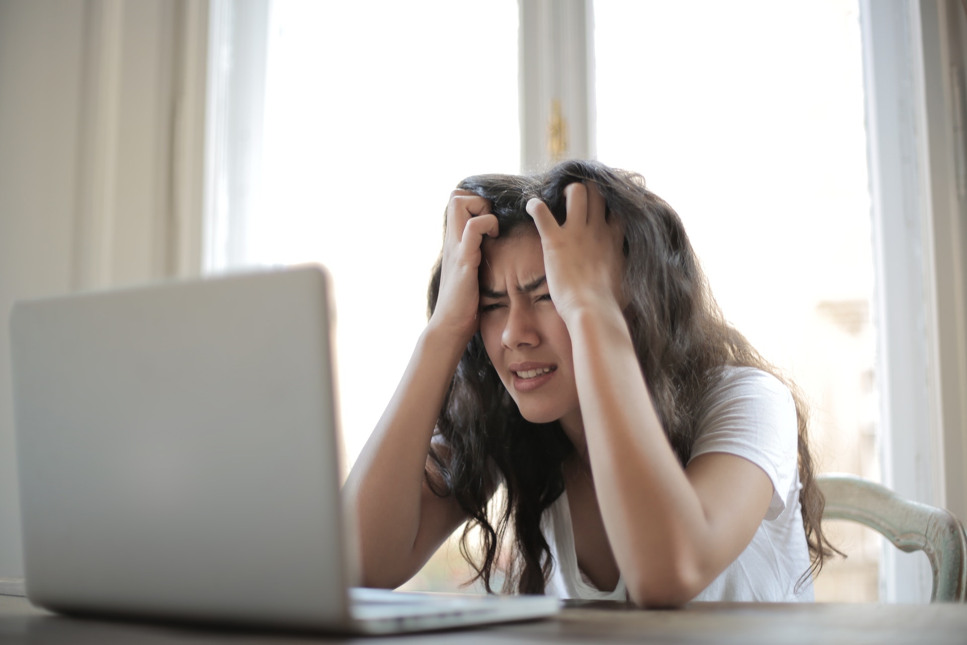 woman in white t shirt showing frustration 